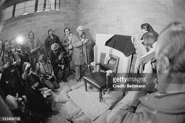 Point of the Mountain, Utah: Photo of a group of newsmen looking at, and taking photos of the chair in which Gary Gilmore sat when facing the firing...