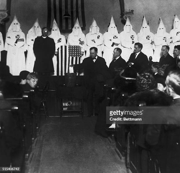 Chicago, Illinois: Members of the hooded Ku Klux Klan attending church services at the Pacific Congregational Church in Chicago. The Klansmen...