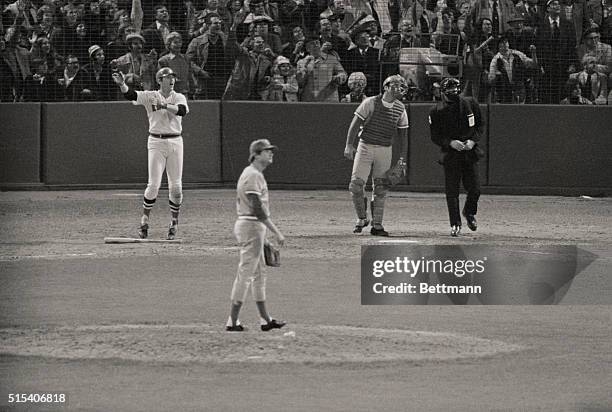 Carlton Fisk hits the ball in the 12th inning for a home run, winning the game 7-6 and tieing the series 3-3.