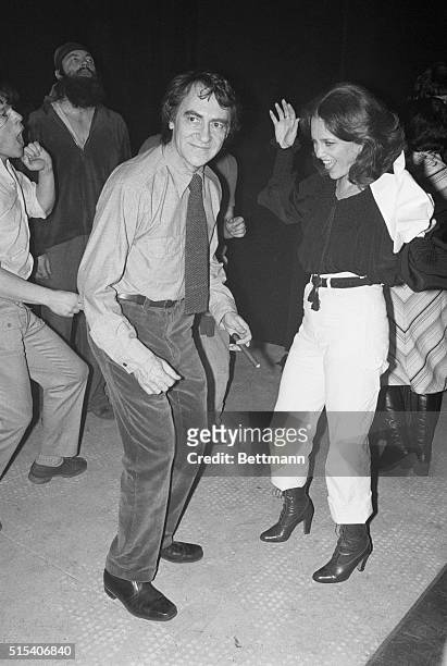 Producer Joseph Papp holds a cigar and seems to be enjoying his attempt to dance with actress Madeline Kahn at a party he threw following the opening...