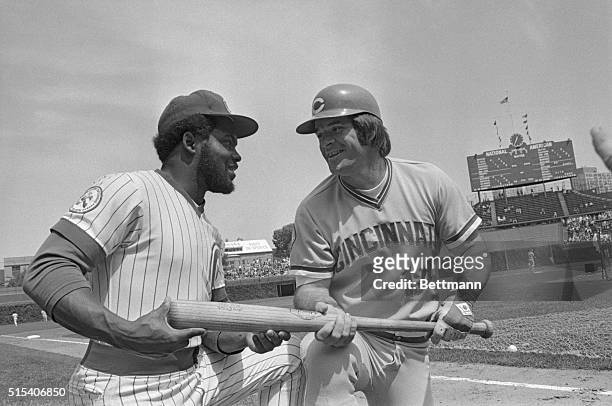 Batting giants, Bill Madlock of the Chicago Cubs, and Cincinnati Reds' Pete Rose exchange techniques prior to the Cubs-Reds game here August 10. Both...