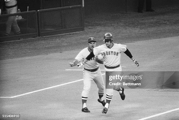 Cincinnati: Red Sox' Carlton Fisk rounds third on second inning homer against the Reds. Bosox coach is Don Zimmer.