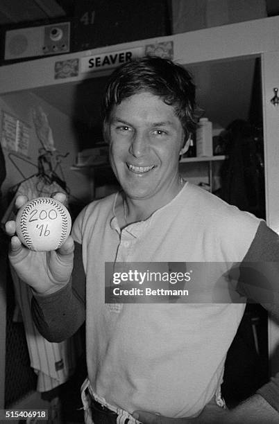 Smiling Tom Seaver of the New York Mets holds up the game ball here, given to him after posting his fourth shutout and struck out eight to reach the...