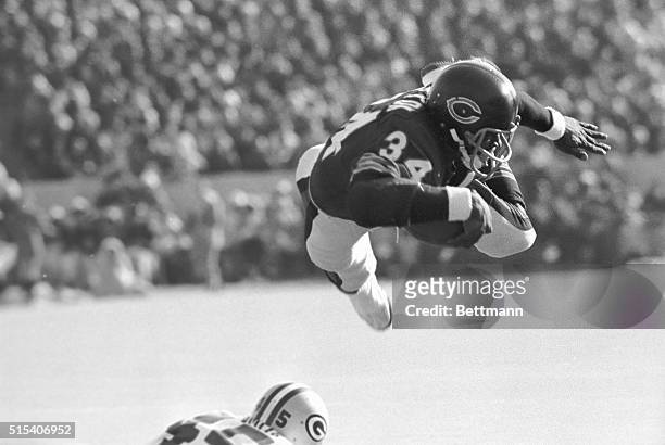 Chicago Bears' RB Walter Payton goes over the Green Bay Packers' line like a missile for shot gain and a first down on the 7-yard line in the first...