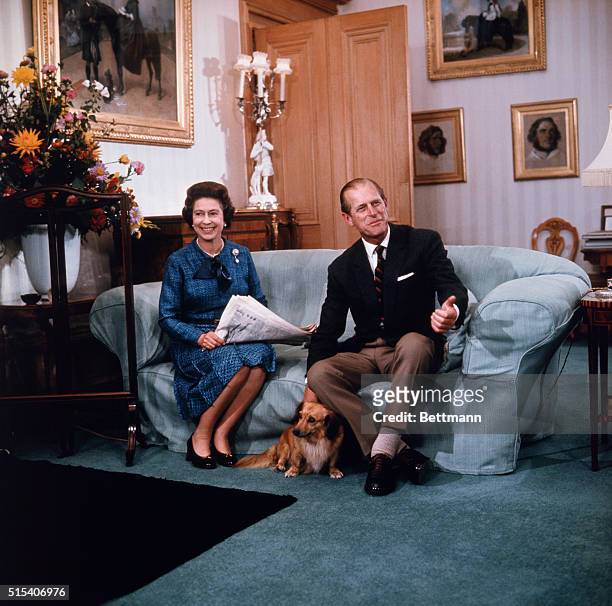 London: Queen Elizabeth II and Prince Philip relax at Balmoral castle in this 9/76 photo, released when she formally opened Parliament, last month....