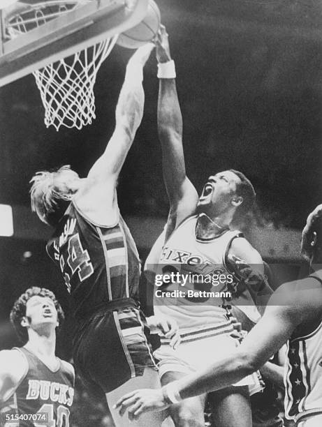 March 24, 1978 - Philadelphia's Joe Bryant attempts a lay up over Milwaukee's Kent Benson as Milwaukee's John Gianelli looks on in the first period...