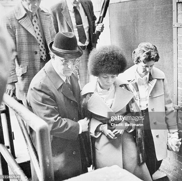 New Brunswick, N.J.: Reputed black militant leader Joanna Chesimard leaves Middlesex County court April 25, escorted by County Sheriff Joseph...