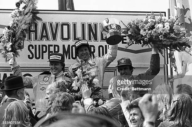 The 1978 Belgium Grand Prix winner Mario Andretti of USA lifts his trophy with second placed Ronnie Peterson of Sweden and 3rd placed Carlos...