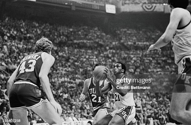 Kentucky Wildcats Jack Givens takes aim before shooting as he is guarded by Duke's Bob Bander in the second half of their NCAA championship game...