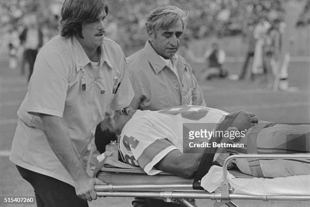 Darryl Stingley, the New England Patriot's outstanding wide receiver, is removed from playing field after he suffered a broken neck here in the...