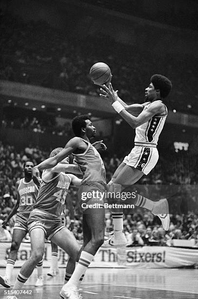 Philadelphia 76ers' Julius Erving leaps up against Houston Rockets' Moses Malone in the fourth quarter in Philadelphia 5/8. Erving scored on the play...