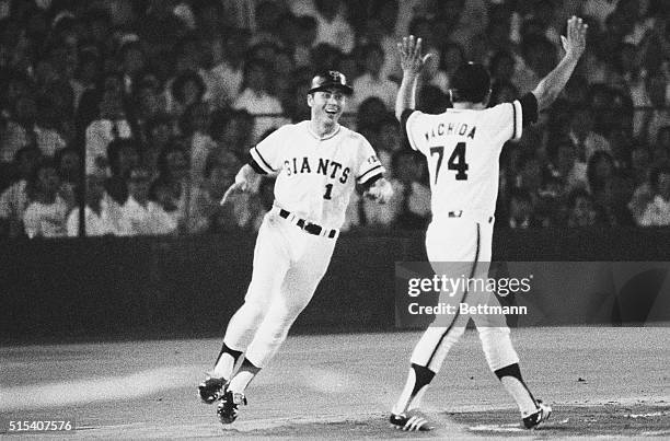 Tokyo: Japan's best known slugger Sadaharu Oh, , of the Yomiuri Giants, is celebrated by first base coach Yukihiko Machida, as he runs on the diamond...