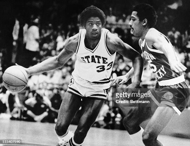 Earvin Johnson a freshman for Michigan State, drives past Western Kentucky's Darryl Turner on his way to the basket. Michigan led WKO at the half,...
