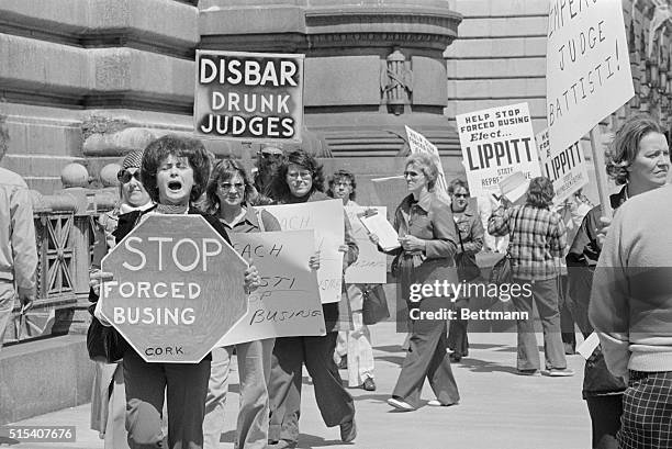 Anti-busing demonstrators parade in front of the Federal Court Building 4/26. Busing foes were also circulating petitions for ousting federal Judge...