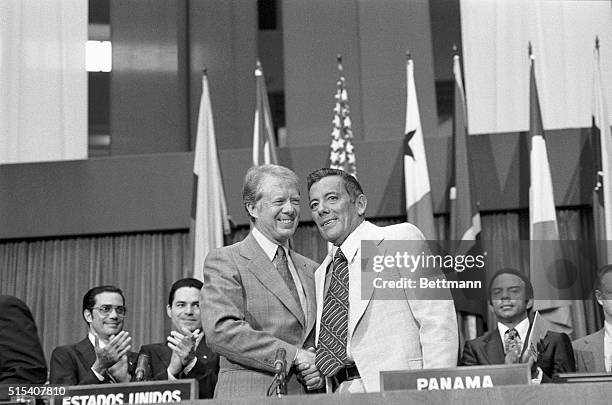 Panama City, Panama- President Carter and General Omar Torrijos, Panama's military ruler, shake hands after they signed the ratified Panama Canal...
