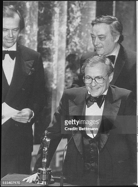 Producer Charles H. Joffe accepts Woody Allen's Best Director Oscar for Annie Hall during the 50th Academy Awards. In the background are actor Jack...