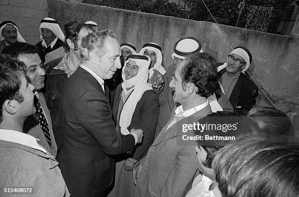 Defense Minister and Acting Prime Minister Shimon Peres jokes with Israeli Arabs while campaigning here over the weekend. Israelis go to the polls...