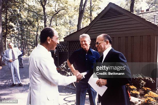 Egyptian President Anwar Sadat and Israeli Prime Minister Menachem Begin shake hands with at the start of the second trilateral meeting with US...