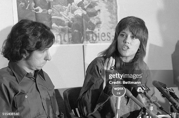 New York, NY- While her fiance, anti-war activist Tom Hayden, looks on, actress Jane Fonda gestures during a press conference on Vietnam...