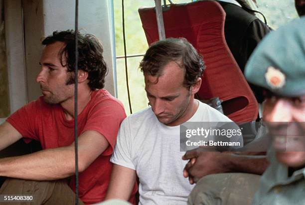 Two members of the People's Temple are held in custody in Georgetown, Guyana, on November 22, 1978 following the Jonestown massacre. At left is...