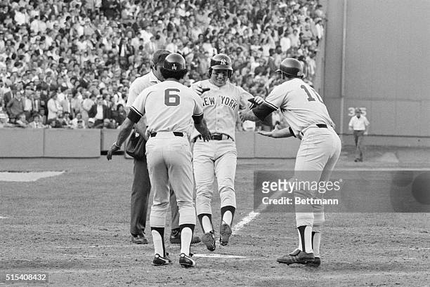Bucky Dent is a happy fellow as he jumps on home plate and is greeted by Roy White and Chris Chambliss after he hit a three-run home run in the 7th...