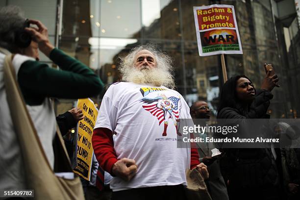 Joe Friendly, a supporters of presidental candidate Bernie Sanders, joins peace activists while they take part in a rally and march protesting Donald...