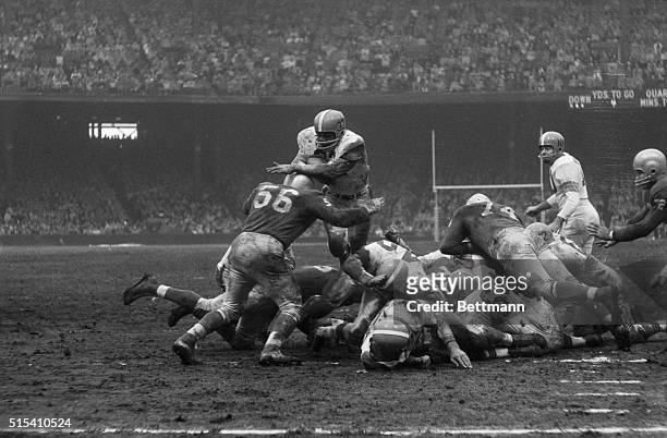 Detroit, MI- Cleveland Browns' fullback Jim Brown tries to hurdle the Detroit line to make a first down on the Lions' four-yard line in the fourth...