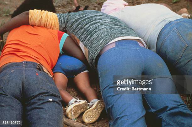 Jonestown, Guyana: Many of the bodies in Jonestown were found clutching each other as if in a final embrace. Note body of small child in left side of...