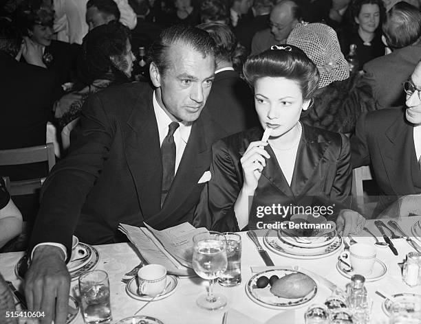 Hollywood, CA-: Gary Cooper, winner of the 1941 award for his portrayal of Sergeant York, and Gene Tierney attend the annual Academy of Motion...