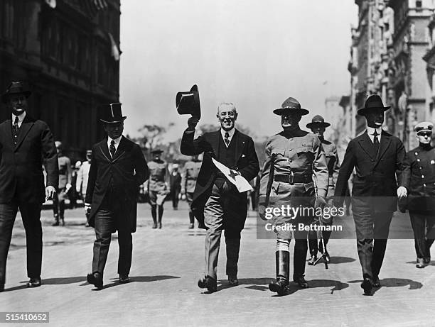 Ca. 1917-: Secretary Tumulty, President Woodrow Wilson, and General Dyer marching in a Red Cross parade.