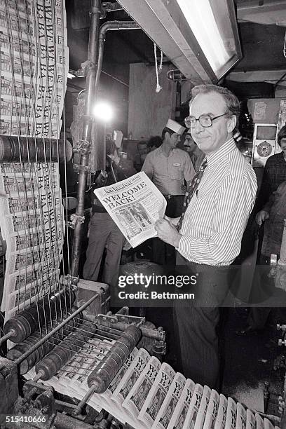 Publisher Rupert Murdoch holds up a copy of the New York Post Oct. 5 as the afternoon daily was back on the street for the first time after a 57-day...