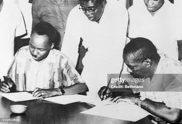 Zanzibar- President Julius Nyerere, , of Tanganyika and President Abeid Karume of Zanzibar sign articles of union under which the two countries will...