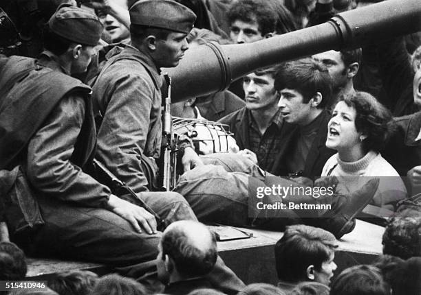 Prague, Czechoslovakia-: This young Czech girl lets her feelings be known as she shouts "Ivan GO Home!" to soldiers sitting on tanks in the streets...