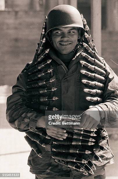 Beirut, Lebanon-: A Lebanese Army soldier poses for photographers 2/16, in the port area of East Beirut, while draped with a large cartridge belt of...