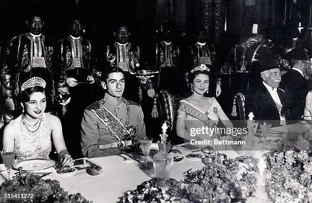 Cairo, Egypt-: Crown Prince Mohamed Rida Chabour of Iran is shown seated between his bride, Princess Fawzia , sister of King Farouk of Egypt, and...