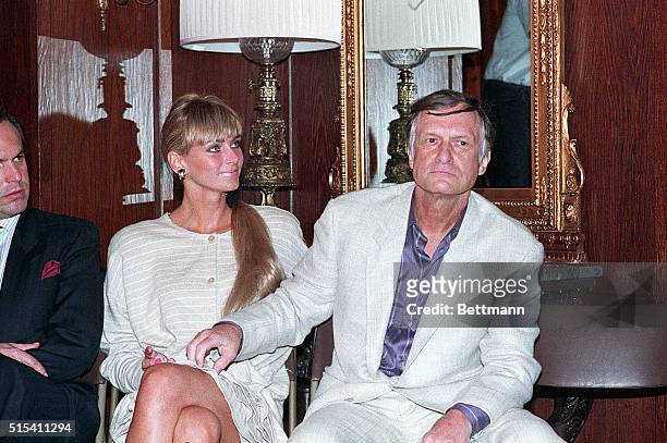 Los Angeles, California- Hugh Hefner tickles the leg of his latest significant other, Kimberly Conrad who was Playboy's centerfold, before speaking...