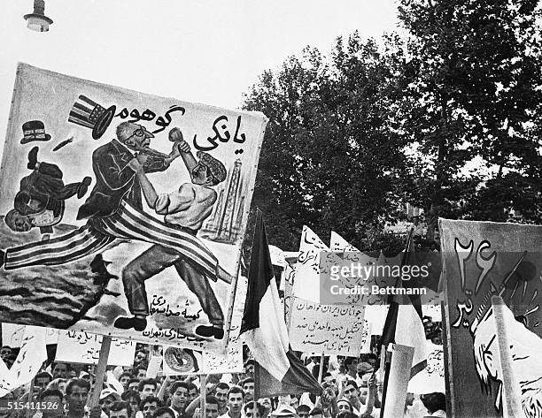 Teheran, Iran- Members of the Tudeh Party in Iran carry placards which denounce the United States and Great Britain during a powerful demonstration...
