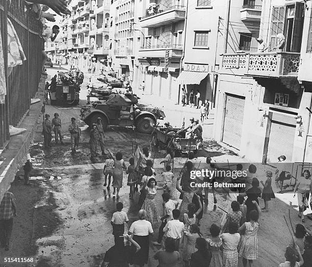 Beirut, Lebanon-: Women Phalangists wave their broomsticks in defiance of Lebanese Army tanks, during a street battle. Four people were reported...