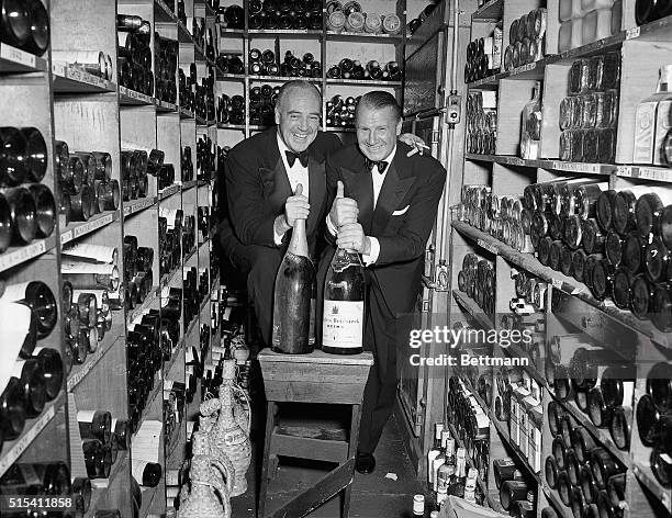 New York, NY: At the El Morocco Club, smiling waiters shows off their treasure of wines and champagnes from the cellar of their club.