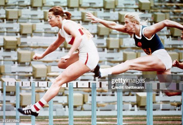 Munich, Germany: Heide Rosendahl, of West Germany, leaps over a hurdle to break the record in the 100 meter hurdles leg of the Women's Pentathlon...