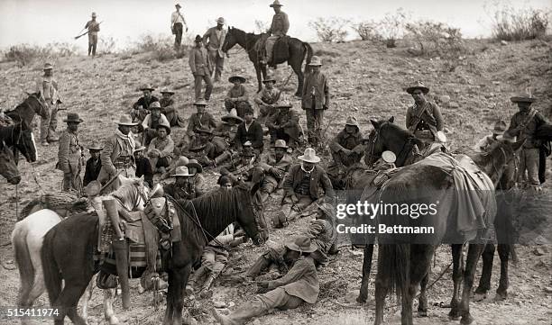 Mexico: Pancho Villa and his men take a break. Villa is the man in the large hat, seated on the ground facing the camera, looking downward, between...