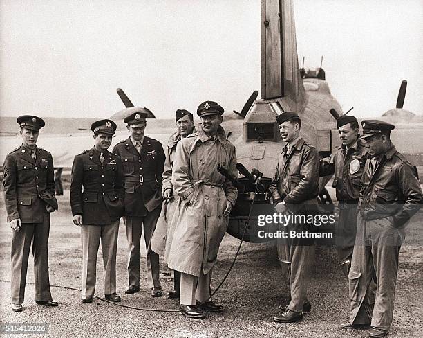 England-Former film star, Captain Clark Gable is shown on an airfield somewhere in England with the crew of a Flying Fortress. Gable, now serving...
