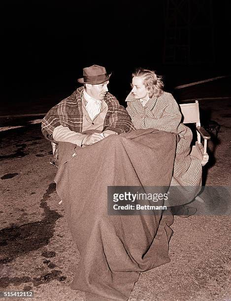Clark Gable and Carole Lombard chat in a cold parking lot, during night shooting for Too Hot to Handle, which starred Gable. Less than a year later...