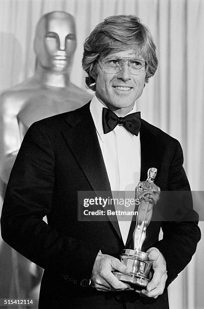 Hollywood, CA-: Robert Redford admires his Oscar after he won it for Best Achievement for Directing in the movie, Ordinary People. The Oscar was one...