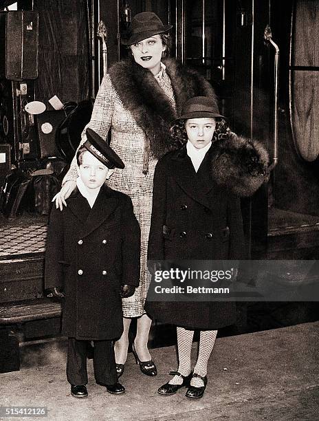 London, England-: Dolores Costello Barrymore, former wife of actor John Barrymore, and her children, John and Dolores, leave Waterloo Station in...