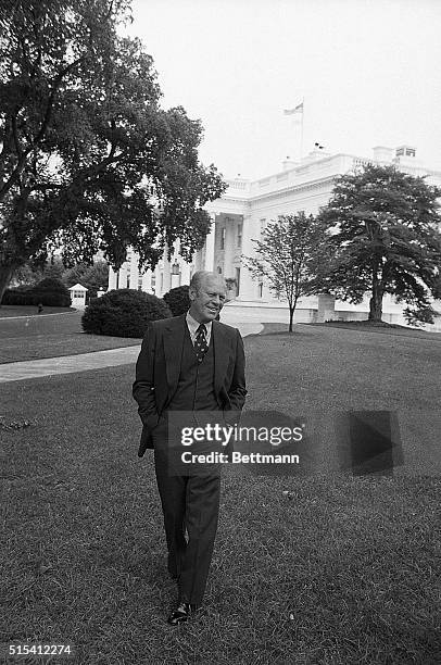Washington, DC-: President Ford is all smiles as he comes out on the White House lawn, after announcing that he and opponent Jimmy Carter have agreed...