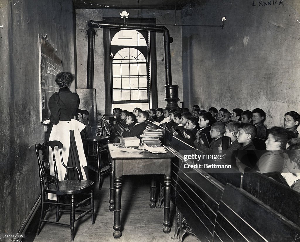Teacher Instructing Schoolboys in Small Classroom