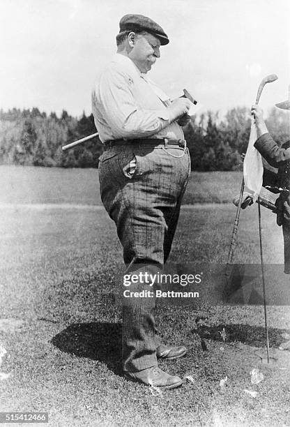 President William Howard Taft playing golf. He is shown just after hitting a shot.