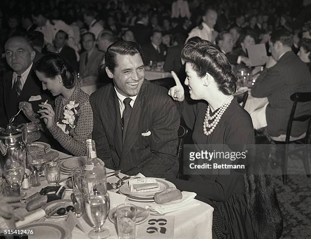 Hollywood, CA-Cary Grant and Rosalind Russell are shown here attending the war crimped awards banquet of the Academy of Motion Picture Arts and...
