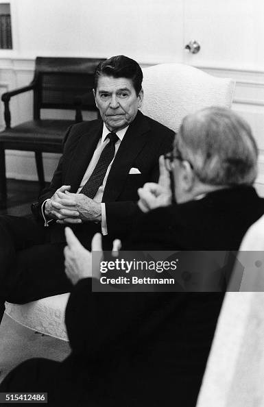 Ronald Reagan in Chair Listens to a Man